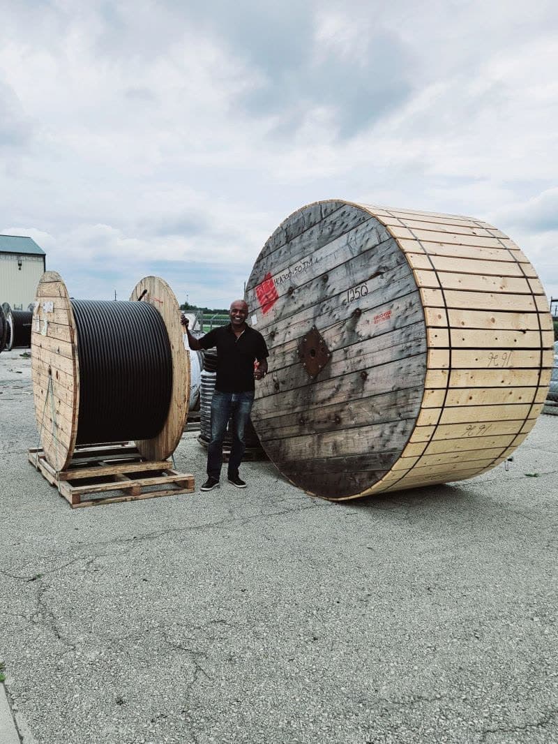 TrustClarity founder standing next to industrial cable spools at a supplier site